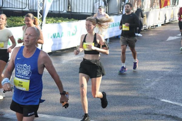 A runner approaching the finish line at a community race