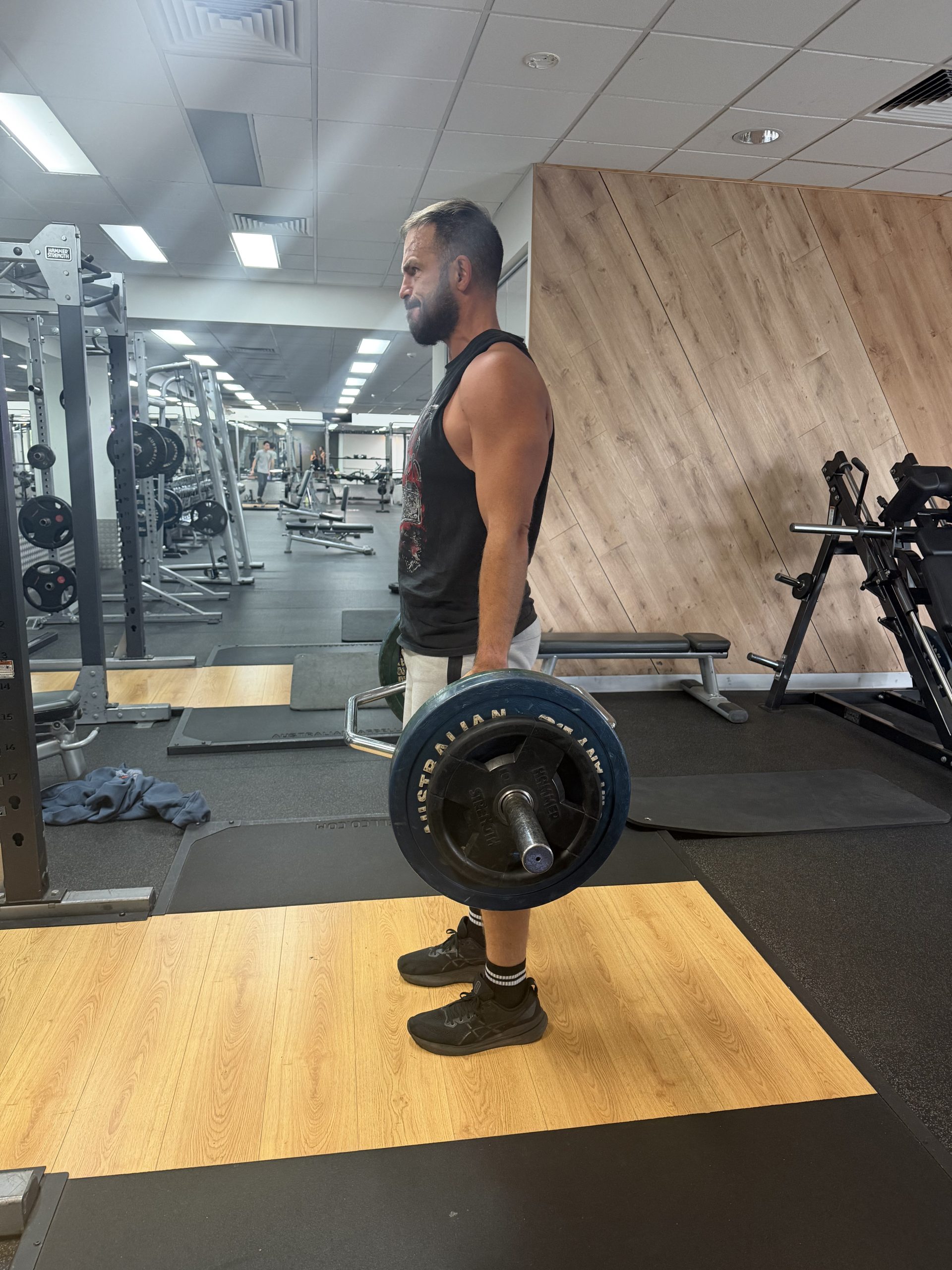 Brad lifting a loaded barbell from the floor