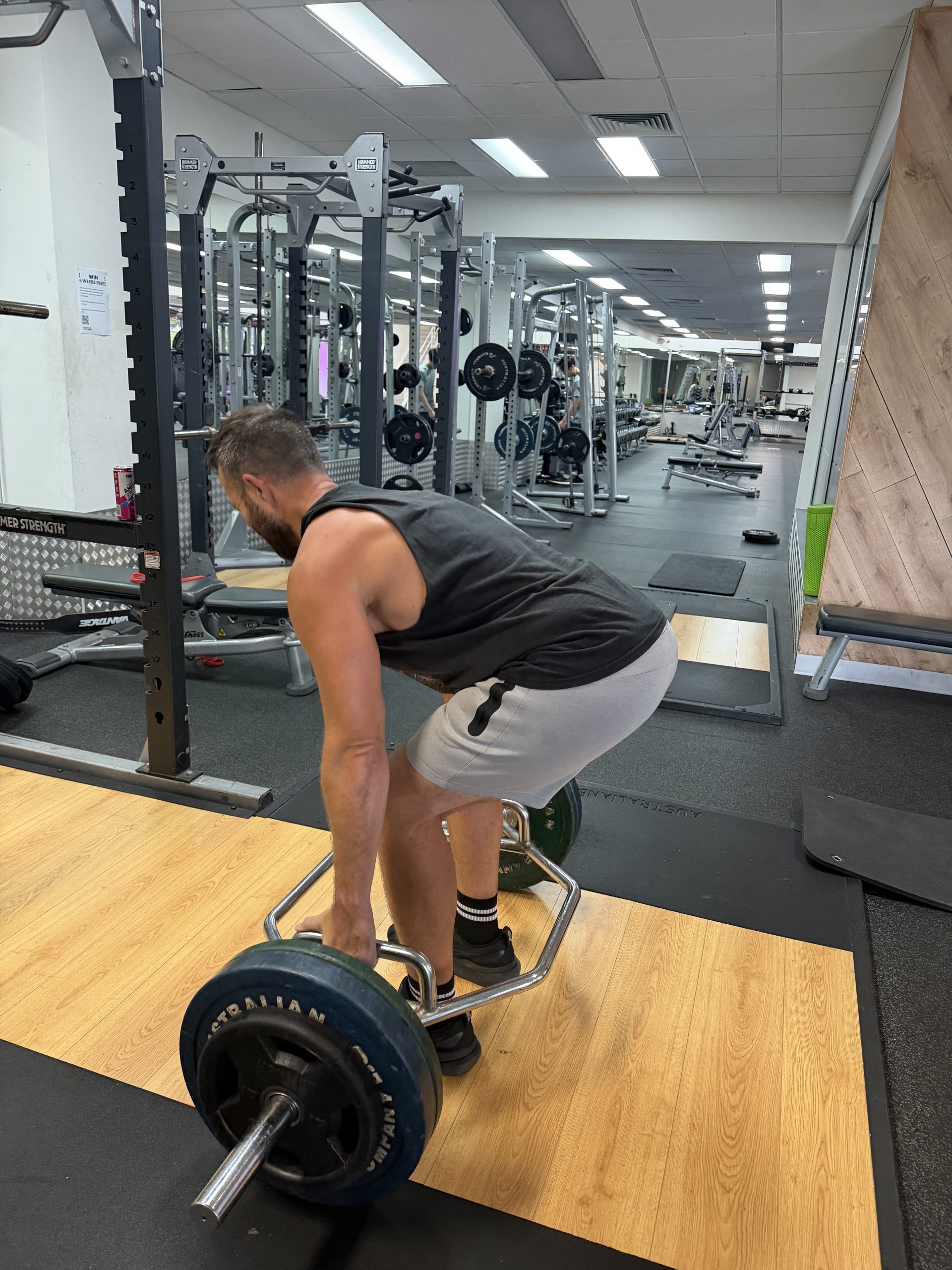 Brad setting up for a barbell deadlift in the gym