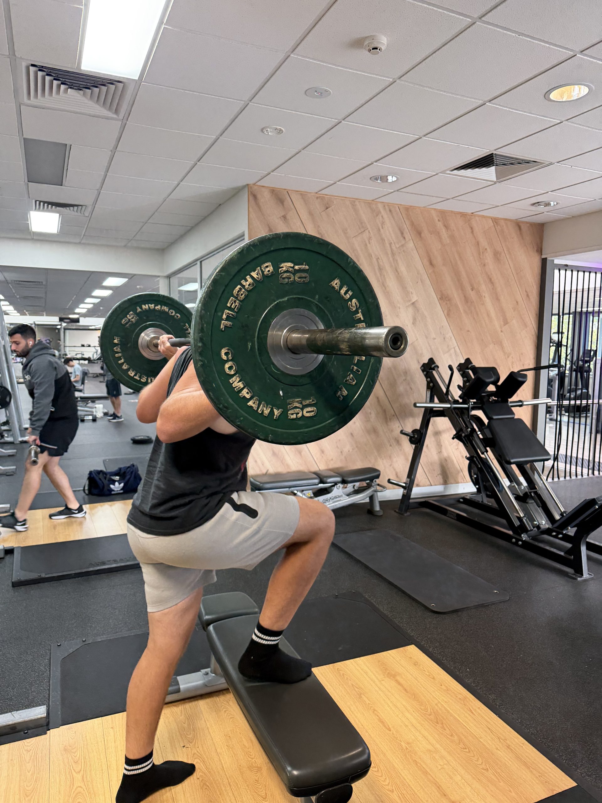 Brad holding a loaded barbell in the front rack position