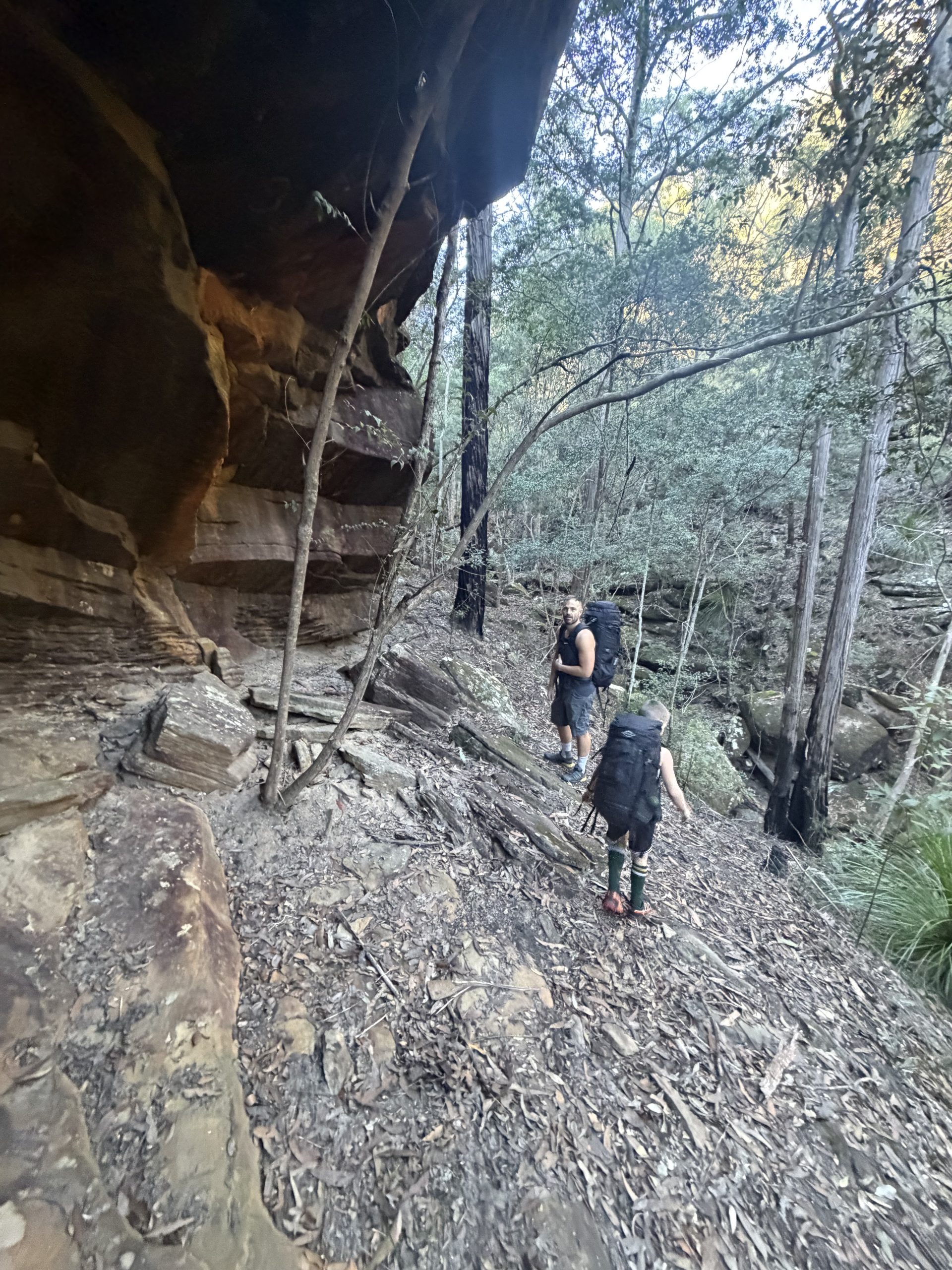 Walking in under a rock overhang