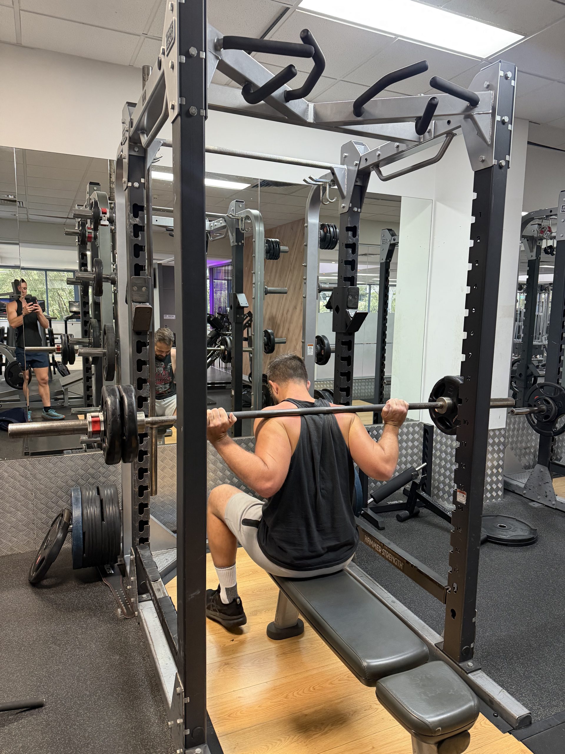 Brad under the bar in the squat rack